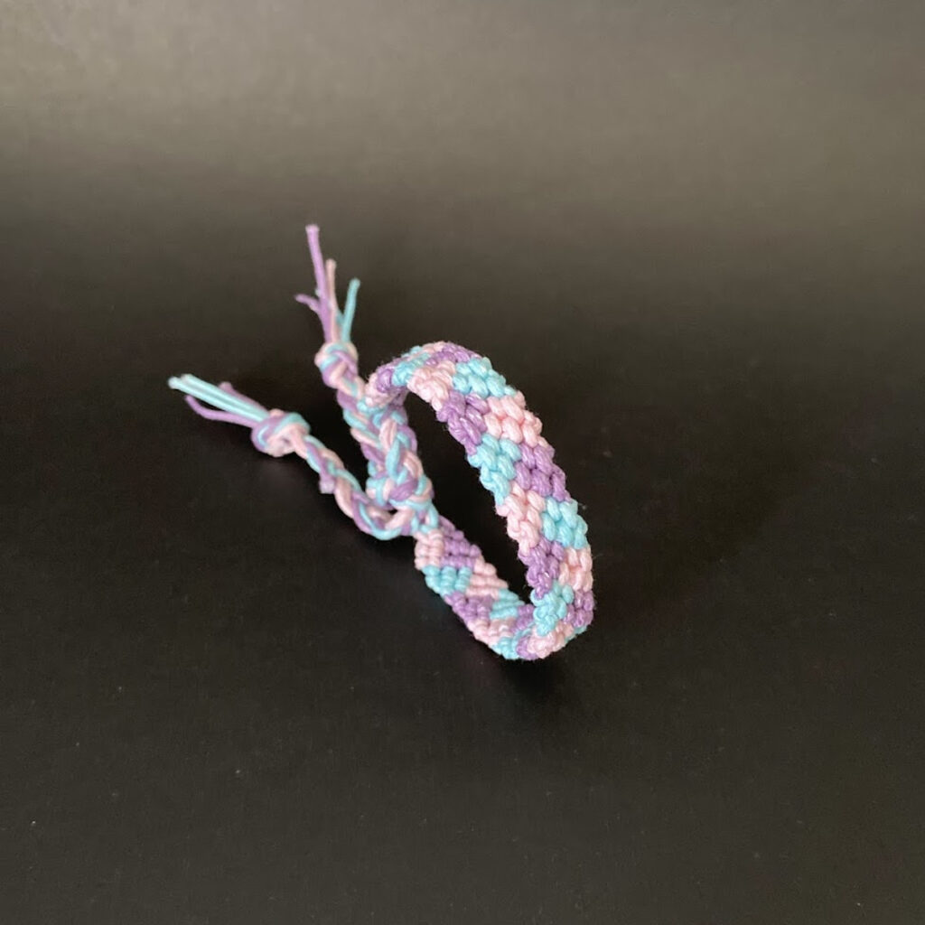 Macrame bracelet with 3 colours - pink, light blue and light purple. Featured for friendship.